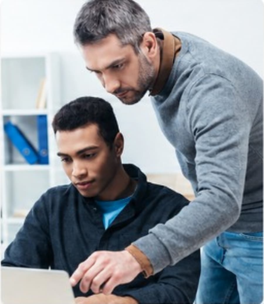 Tutor helping a student work through a lesson on a laptop